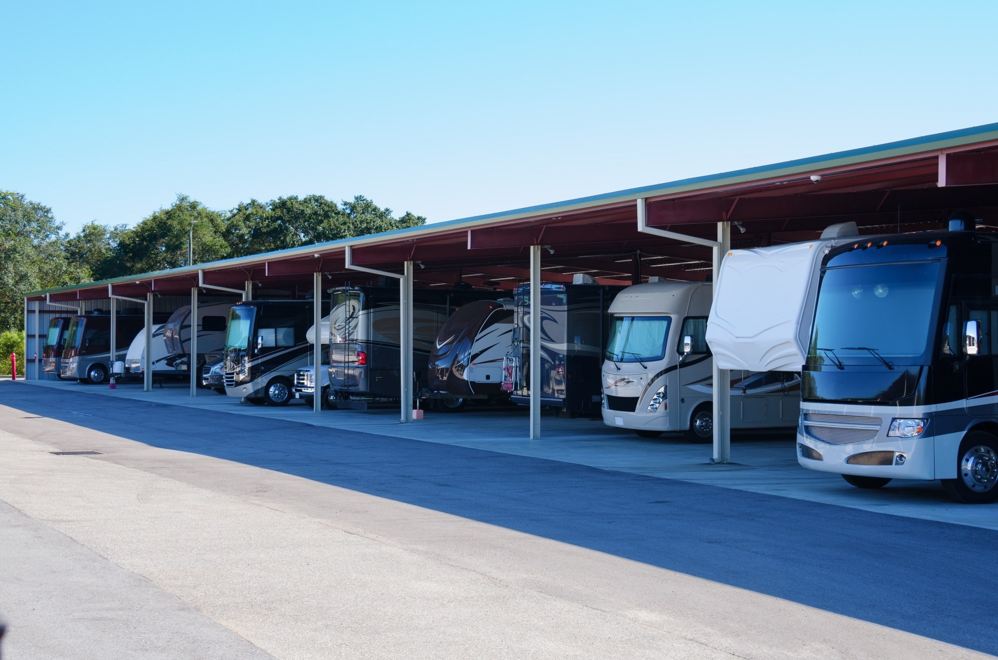 A Group Of RVS Parked In A Parking Lot